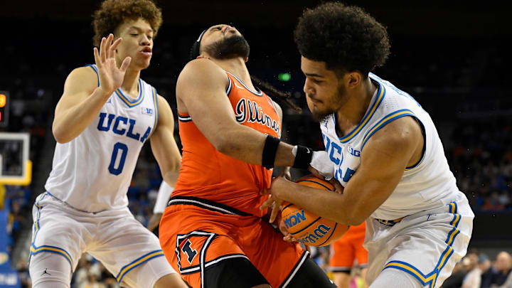 Feb 21, 2026; Los Angeles, California, USA; Illinois guard Kylan Boswell (4) and UCLA guard Eric Freeny (8) fight for the ball as UCLA guard Trent Perry (0) (left) looks on during the second half at Pauley Pavilion presented by Wescom Financial. Mandatory Credit: Robert Hanashiro-Imagn Images