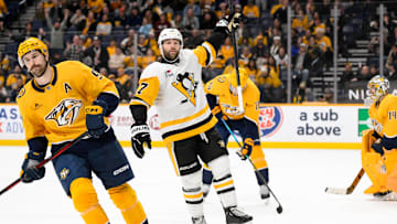 Dec 19, 2024; Nashville, Tennessee, USA;  Pittsburgh Penguins right wing Bryan Rust (17) celebrates the game winner against the Nashville Predators during the 1st overtime period at Bridgestone Arena. Mandatory Credit: Steve Roberts-Imagn Images