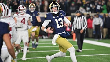 Dec 20, 2024; Notre Dame, Indiana, USA; Notre Dame Fighting Irish quarterback Riley Leonard (13) runs for a touchdown during the second half against the Indiana Hoosiers at Notre Dame Stadium. Mandatory Credit: Matt Cashore-Imagn Images