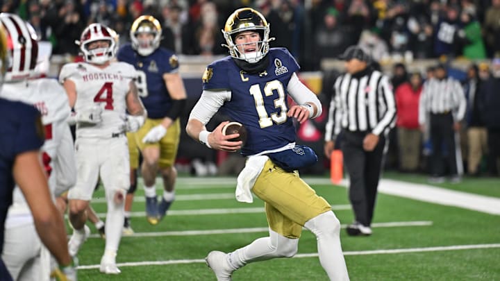 Dec 20, 2024; Notre Dame, Indiana, USA; Notre Dame Fighting Irish quarterback Riley Leonard (13) runs for a touchdown during the second half against the Indiana Hoosiers at Notre Dame Stadium. Mandatory Credit: Matt Cashore-Imagn Images