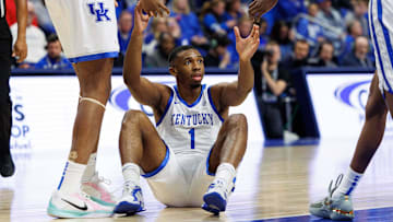 Nov 26, 2024; Lexington, Kentucky, USA; Kentucky Wildcats guard Lamont Butler (1) is helped to his feet during the second half against the Kentucky Wildcats at Rupp Arena at Central Bank Center. Mandatory Credit: Jordan Prather-Imagn Images