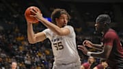 Dec 9, 2025; Morgantown, West Virginia, USA; West Virginia Mountaineers center Harlan Obioha (55) grabs a rebound during the first half against the Little Rock Trojans at Hope Coliseum. Mandatory Credit: Ben Queen-Imagn Images
