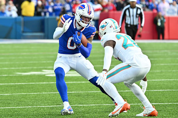 Buffalo Bills WR Keon Coleman tries to avoid a tackle by Miami Dolphins safety Marcus Maye.