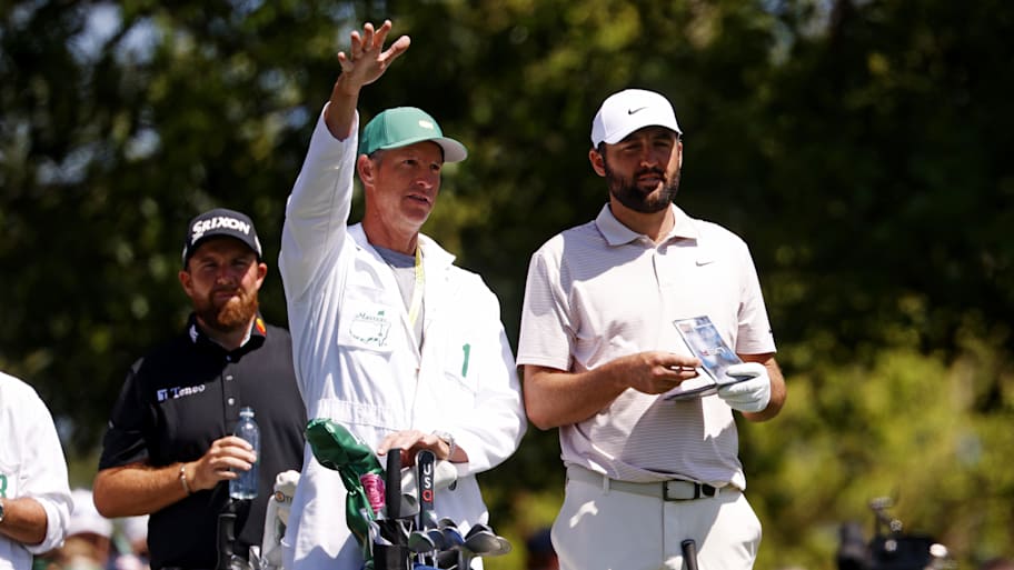 Scottie Scheffler and his caddy, Ted Scott, discuss on the fourth green during the final round of the 2025 Masters.