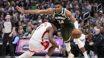 Nov 18, 2024; Milwaukee, Wisconsin, USA;  Milwaukee Bucks forward Giannis Antetokounmpo (34) fouls Houston Rockets guard Amen Thompson (1) during the fourth quarter at Fiserv Forum. Mandatory Credit: Jeff Hanisch-Imagn Images