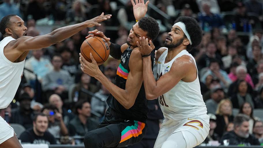 San Antonio Spurs forward Victor Wembanyama drives against Cleveland Cavaliers center Jarrett Allen.