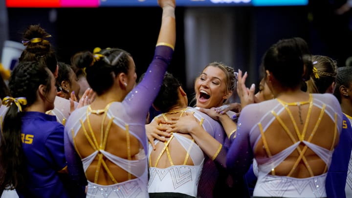 Feb 2, 2024; Baton Rouge, LA, USA;  LSU senior Olivia Dunne, facing camera, hugs Haleigh Bryant after she scored a perfect 10 on her floor routine against the Arkansas Razorbacks at Pete Maravich Assembly Center. 