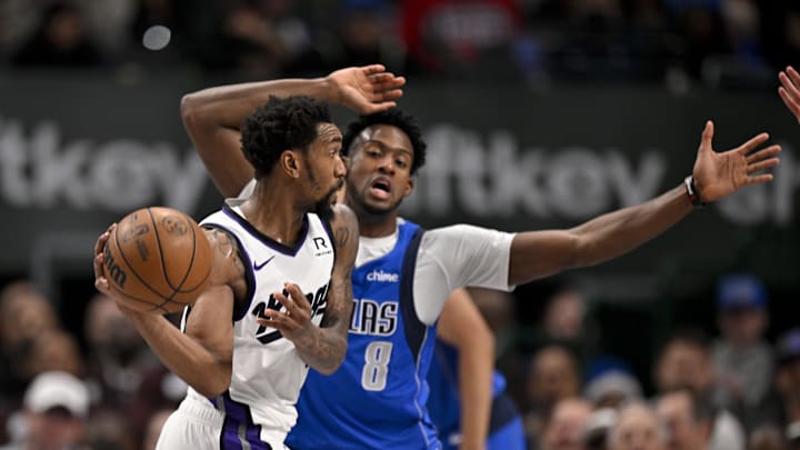 Feb 10, 2025; Dallas, Texas, USA; Sacramento Kings guard Malik Monk (0) looks to pass the ball past Dallas Mavericks forward Olivier-Maxence Prosper (8) during the second quarter at the American Airlines Center. Mandatory Credit: Jerome Miron-Imagn Images