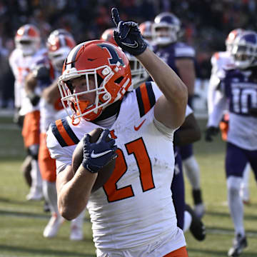 Nov 30, 2024; Chicago, Illinois, USA;  Illinois Fighting Illini running back Aidan Laughery (21) runs for a touchdown against Northwestern Wildcats during the first half at Wrigley Field. Mandatory Credit: Matt Marton-Imagn Images