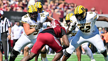 Oct 12, 2024; Amherst, Massachusetts, USA; Missouri Tigers offensive lineman Mitchell Walters (75) and offensive lineman Marcus Bryant (52)  blocking Massachusetts Minutemen defensive end Kofi Asare (94) during the first half at Warren McGuirk Alumni Stadium. Mandatory Credit: Eric Canha-Imagn Images