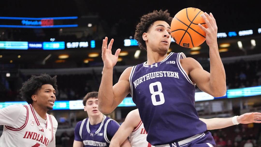 Mar 11, 2026; Chicago, IL, USA; Northwestern Wildcats forward Tre Singleton (8) grabs a rebound against the Indiana Hoosiers during the first half at United Center. 