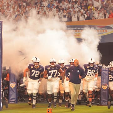 Penn State football coach James Franklin leads the Nittany Lions onto the field for the Orange Bowl vs. the Notre Dame Fighting Irish.