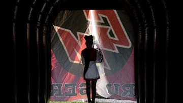 August 23, 2024; Groveport, Ohio, USA; 
A Groveport Madison cheerleader peeks out from the team’s tunnel before Friday night’s game against Hilliard Bradley on Le’Veon Bell Field at Cruiser Stadium.