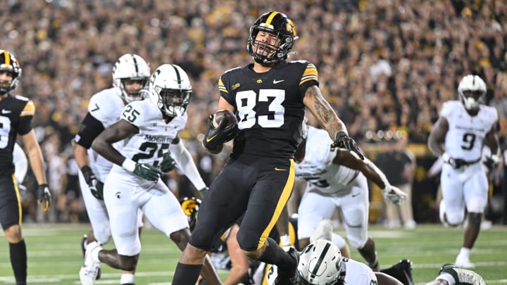 Sep 30, 2023; Iowa City, Iowa, USA; Iowa Hawkeyes tight end Erick All (83) scores on a touchdown pass as Michigan State Spartans running back Jalen Berger (8) attempts to make the tackle during the second quarter at Kinnick Stadium. Mandatory Credit: Jeffrey Becker-USA TODAY Sports