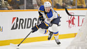 Mar 18, 2025; Nashville, Tennessee, USA;  St. Louis Blues center Dylan Holloway (81) skates behind the net against the Nashville Predators during the first period at Bridgestone Arena. Mandatory Credit: Steve Roberts-Imagn Images