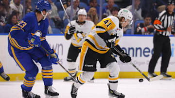 Sep 21, 2024; Buffalo, New York, USA;  Buffalo Sabres defenseman Mattias Samuelsson (23) watches as Pittsburgh Penguins center Ville Koivunen (41) tries to control the puck during the first period at KeyBank Center. Mandatory Credit: Timothy T. Ludwig-Imagn Images