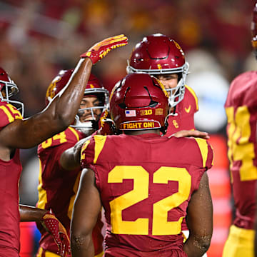 Sep 7, 2024; Los Angeles, California, USA; USC Trojans running back A'Marion Peterson (22) celebrates with teammates after scoring a touchdown against the Utah State Aggies during the fourth quarter at United Airlines Field at Los Angeles Memorial Coliseum. Mandatory Credit: Jonathan Hui-Imagn Images