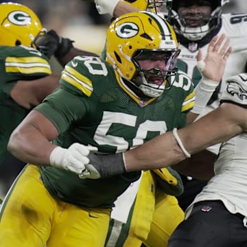 Green Bay Packers offensive tackle Zach Tom (50) blocks Philadelphia Eagles linebacker Jaelan Phillips (50) while providing pass protection for quarterback Jordan Love during the fourth quarter of their game Monday, November 10, 2025 at Lambeau Field in Green Bay, Wisconsin.