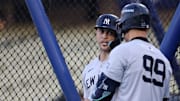 Oct 24, 2024; Los Angeles, CA, USA;  New York Yankees designated hitter Giancarlo Stanton (27) talks to outfielder Aaron Judge (99) during workout day at Dodgers Stadium. 