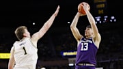 Jan 19, 2025; Ann Arbor, Michigan, USA;  Northwestern Wildcats guard Brooks Barnhizer (13) shoots on Michigan Wolverines center Danny Wolf (1) in the second half at Crisler Center. Mandatory Credit: Rick Osentoski-Imagn Images