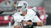 Las Vegas Raiders quarterback Aidan O'Connell (12) warms up