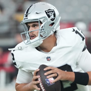 Las Vegas Raiders quarterback Aidan O'Connell (12) warms up