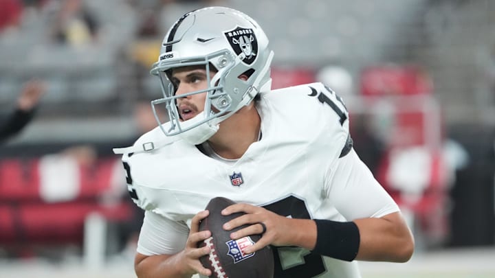Las Vegas Raiders quarterback Aidan O'Connell (12) warms up