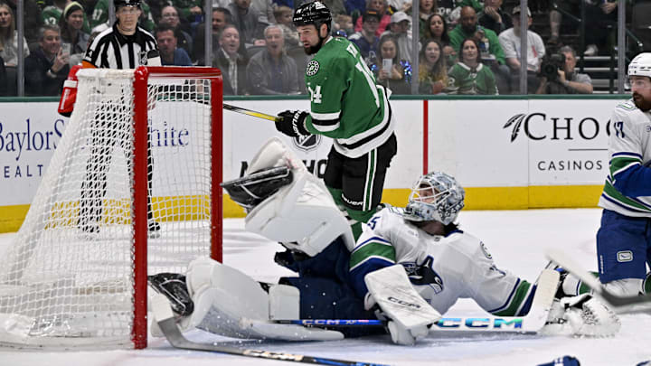 Apr 8, 2025; Dallas, Texas, USA; Dallas Stars center Matt Duchene (not pictured) scores a goal past Vancouver Canucks goaltender Thatcher Demko (35) as left wing Jamie Benn (14) looks on during the second period at the American Airlines Center. Mandatory Credit: Jerome Miron-Imagn Images