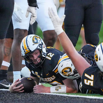 Sep 7, 2024; Columbia, Missouri, USA; Missouri Tigers quarterback Brady Cook (12) runs in for a touchdown against the Buffalo Bulls during the first half at Faurot Field at Memorial Stadium. Mandatory Credit: Denny Medley-Imagn Images