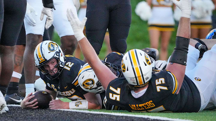 Sep 7, 2024; Columbia, Missouri, USA; Missouri Tigers quarterback Brady Cook (12) runs in for a touchdown against the Buffalo Bulls during the first half at Faurot Field at Memorial Stadium. Mandatory Credit: Denny Medley-Imagn Images