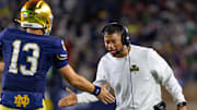 Oct 18, 2025; South Bend, Indiana, USA; Notre Dame Fighting Irish head coach Marcus Freeman celebrates with quarterback CJ Carr (13) during the first half against the Southern California Trojans at Notre Dame Stadium. Mandatory Credit: Michael Caterina-Imagn Images