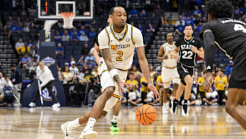 Former Mizzou Tiger guard Tamar Bates (2) drives to the basket against a defender, in a game versus the Mississippi State Bulldogs, in the second round of the SEC Tournament last season.