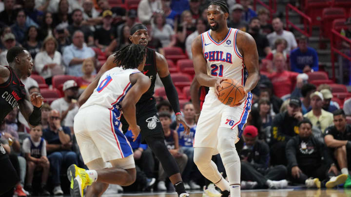 Apr 4, 2024; Miami, Florida, USA;  Philadelphia 76ers center Joel Embiid (21) hands the ball to guard Tyrese Maxey (0) during the first half against the Miami Heat at Kaseya Center. Mandatory Credit: Jim Rassol-USA TODAY Sports