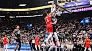 Apr 9, 2025; Salt Lake City, Utah, USA;  Portland Trail Blazers guard Matisse Thybulle (4) dunks over Utah Jazz center Micah Potter (25) in the second half at Delta Center. Mandatory Credit: Jamie Sabau-Imagn Images