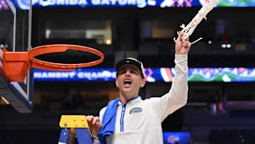 Mar 16, 2025; Nashville, TN, USA; Florida Gators head coach Todd Golden cuts the net after winning the 2025 SEC Championship Game at Bridgestone Arena. Mandatory Credit: Steve Roberts-Imagn Images