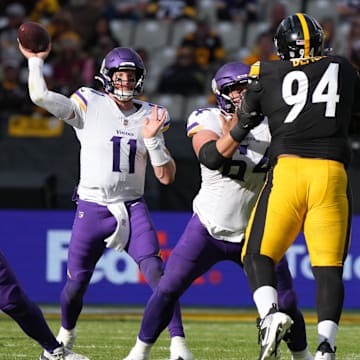 Sep 28, 2025; Dublin, Ireland; Minnesota Vikings quarterback Carson Wentz (11) throws the ball against Pittsburgh Steelers defensive end Demarvin Leal (98) and defensive tackle Yahya Black (94) during an NFL International Series game at Croke Park. Mandatory Credit: Kirby Lee-Imagn Images