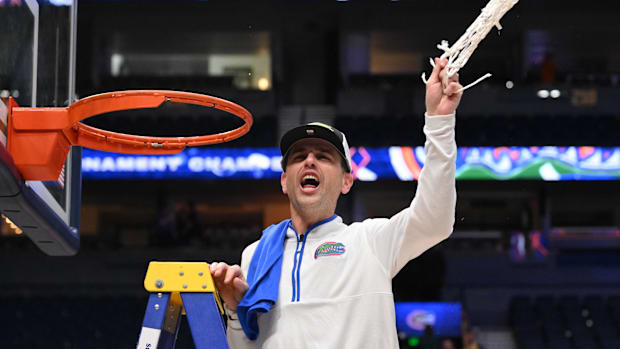 Florida Gators head coach Todd Golden cuts the net after winning the 2025 SEC Championship Game at Bridgestone Arena. 