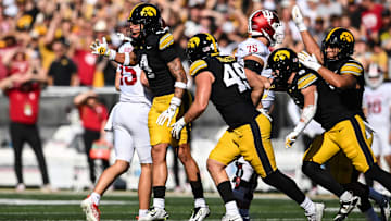 Sep 27, 2025; Iowa City, Iowa, USA; Iowa Hawkeyes defensive back Koen Entringer (4) and defensive lineman Ethan Hurkett (49) and teammates react after a 4th down stop against the Indiana Hoosiers during the second quarter at Kinnick Stadium. Mandatory Credit: Jeffrey Becker-Imagn Images
