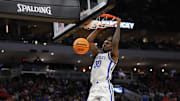 Mar 21, 2025; Milwaukee, WI, USA; Kentucky Wildcats guard Otega Oweh (00) dunks during the second half against the Troy Trojans at Fiserv Forum. Mandatory Credit: Jeff Hanisch-Imagn Images