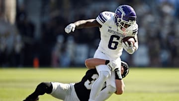 Nov 2, 2024; West Lafayette, Indiana, USA; Northwestern Wildcats running back Joseph Himon II (6) is tackled by Purdue Boilermakers defensive back Dillon Thieneman (31) during the second half at Ross-Ade Stadium. Mandatory Credit: Marc Lebryk-Imagn Images