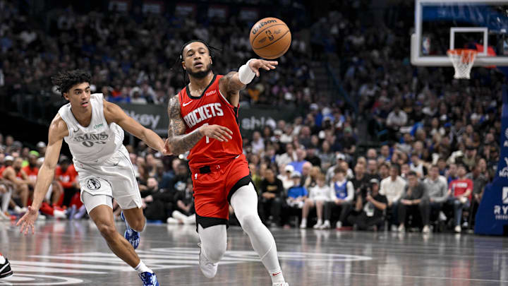 Feb 8, 2025; Dallas, Texas, USA; Houston Rockets forward Cam Whitmore (7) passes the ball by Dallas Mavericks guard Max Christie (00) during the second quarter at American Airlines Center. Mandatory Credit: Jerome Miron-Imagn Images