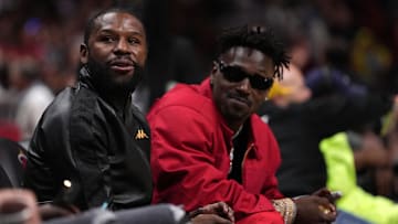 Former boxer Floyd Mayweather Jr. with former NFL player Antonio Brown at an NBA game with the Miami Heat and Brooklyn Nets
