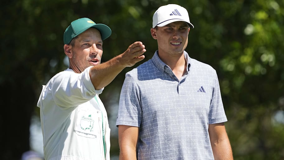 Ludvig Aberg talks with his caddie on the fourth tee during the final round of the 2024 Masters.