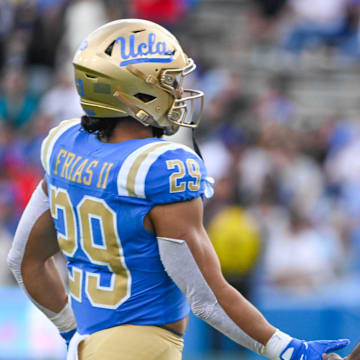 Nov 30, 2024; Pasadena, California, USA; UCLA Bruins head coach DeShaun Foster greets UCLA Bruins running back Anthony Frias II (29) as he returns to the bench during the third quarter against the Fresno State Bulldogs at Rose Bowl. Mandatory Credit: Robert Hanashiro-Imagn Images