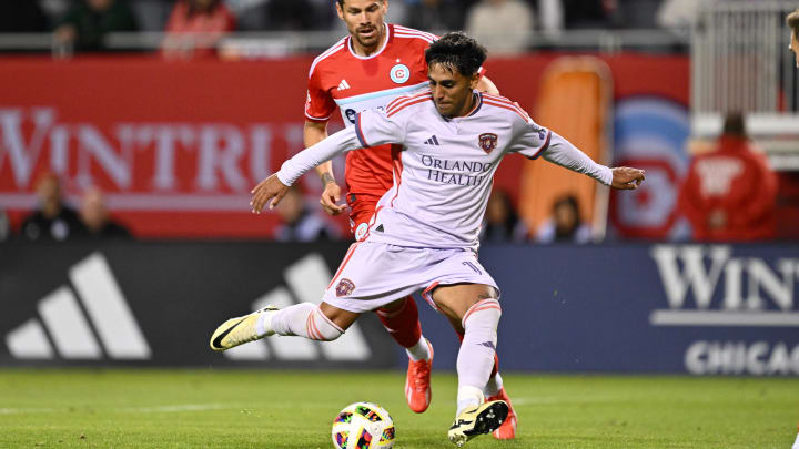 May 29, 2024; Chicago, Illinois, USA;  Orlando City SC midfielder Facundo Torres (10) controls the ball in front of Chicago Fire FC midfielder Gaston Gimenez (30) in the second half at Soldier Field. Mandatory Credit: Jamie Sabau-USA TODAY Sports