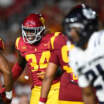 Sep 7, 2024; Los Angeles, California, USA; USC Trojans defensive end Braylan Shelby (34) celebrates after Utah State Aggies quarterback Bryson Barnes (16) (not pictured) is sacked during the third quarter at United Airlines Field at Los Angeles Memorial Coliseum. Mandatory Credit: Jonathan Hui-Imagn Images