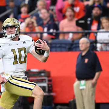 Sep 7, 2024; Syracuse, New York, USA; Georgia Tech Yellow Jackets quarterback Haynes King (10) runs for a touchdown against the Syracuse Orange in the first quarter at JMA Wireless Dome. Mandatory Credit: Mark Konezny-Imagn Images