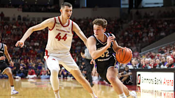 Dec 14, 2024; North Little Rock, Arkansas, USA; UCA Bears guard Layne Taylor (32) drives against Arkansas Razorbacks forward Zvonmiri Ivisic (44) during the first half at Simmons Bank Arena. Mandatory Credit: Nelson Chenault-Imagn Images