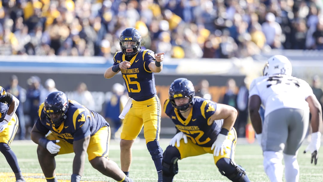 Nov 8, 2025; Morgantown, West Virginia, USA; West Virginia Mountaineers quarterback Scotty Fox Jr. (15) changes the play at the line of scrimmage during the first quarter against the Colorado Buffaloes at Milan Puskar Stadium. Mandatory Credit: Ben Queen-Imagn Images