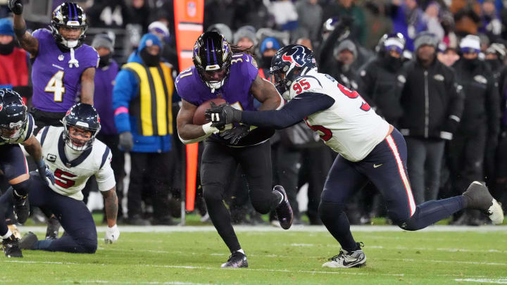 Jan 20, 2024; Baltimore, MD, USA; Baltimore Ravens running back Dalvin Cook (31) runs the ball against Houston Texans defensive end Derek Barnett (95) during the fourth quarter of a 2024 AFC divisional round game at M&T Bank Stadium. Mandatory Credit: Mitch Stringer-USA TODAY Sports